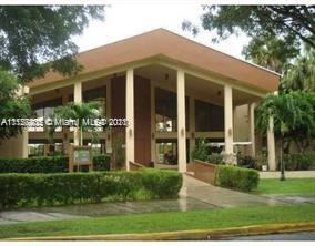 Elevated view of a modern building with large columns and glass windows.