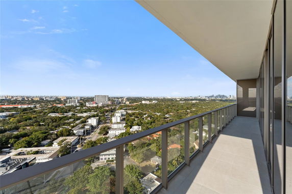 Elevated view from a balcony overlooking a cityscape with clear skies.