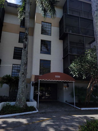 Front view of a multi-story building with a covered entrance.