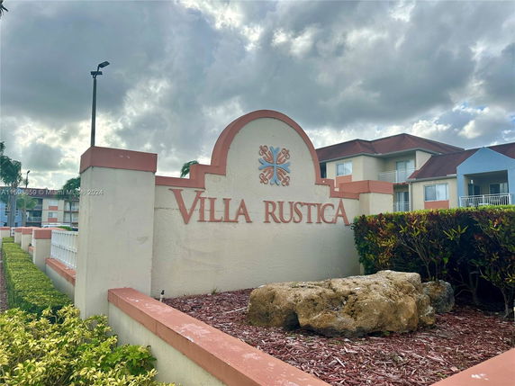 Front view of multi-story buildings with the sign 'Villa Rustica'.
