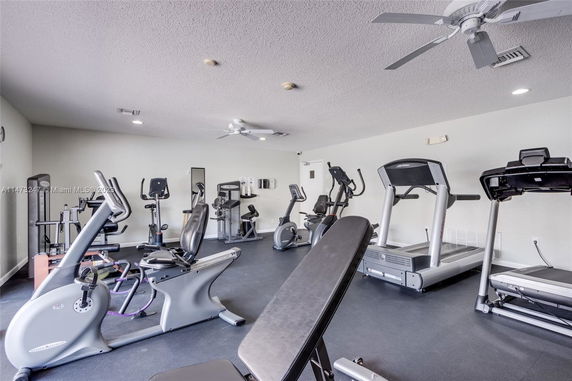 Room equipped with various exercise machines and fitness equipment