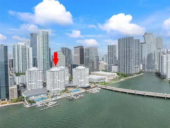 View of a cityscape with multiple high-rise buildings along a waterfront.