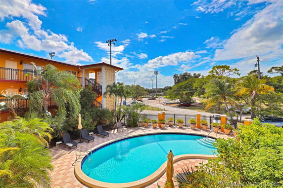 Outdoor area with swimming pool and adjacent building.