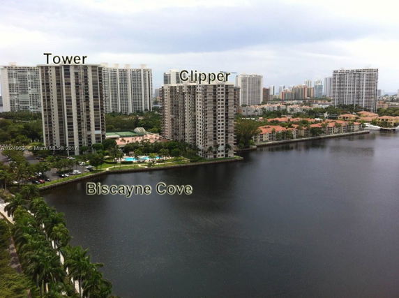 High-rise residential buildings by a waterfront area with surrounding cityscape.