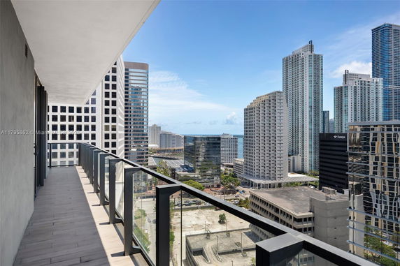Cityscape view from a high-rise building balcony.