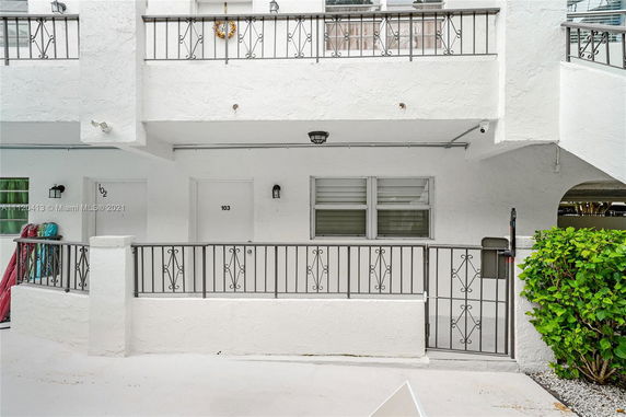 Front view of a building with two doors and metal railings on the exterior.