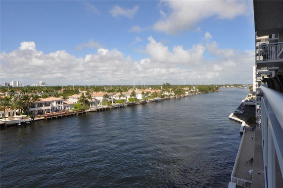 Panoramic view of a waterfront with houses and a river.