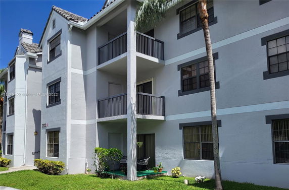 Front view of a multi-story residential building with balconies.
