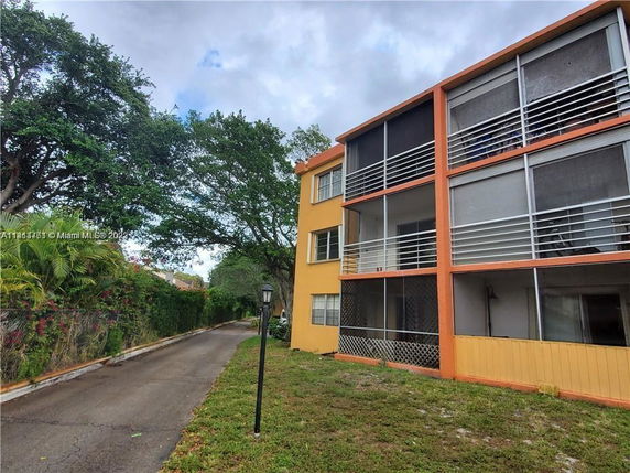 Front view of a multi-story building with balconies.
