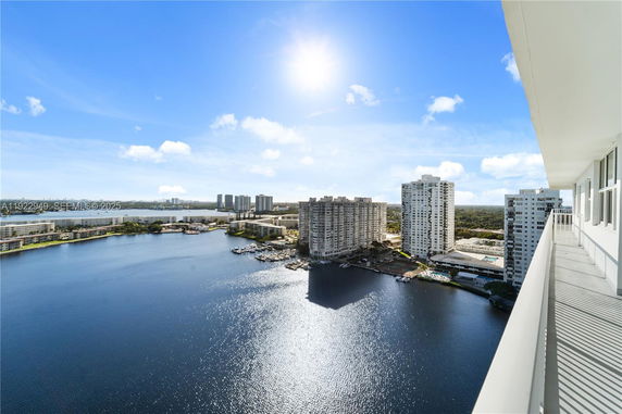 Panoramic view from a high-rise building overlooking water and surrounding skyscrapers.