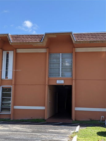 Front view of a two-story building with entrance.