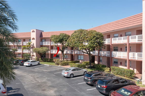 Front view of a three-story apartment building with balconies.