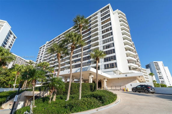 Front view of a multi-story residential building with balconies.