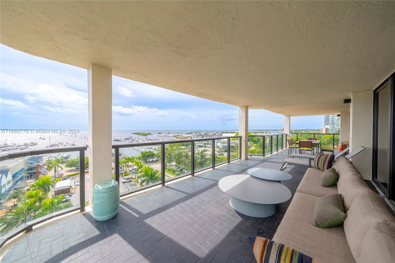 Spacious balcony with a panoramic view of the marina and ocean.