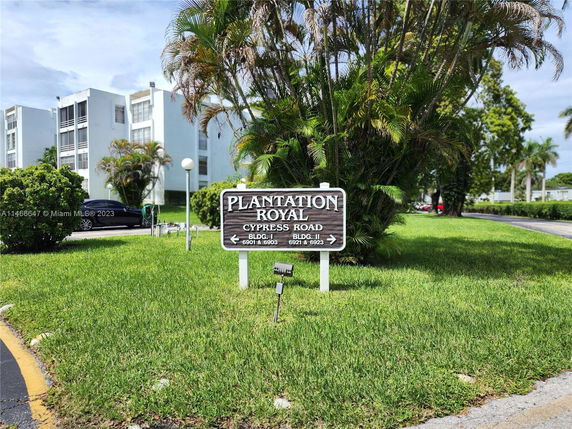 Front view of multi-story residential buildings with a sign for Plantation Royal.