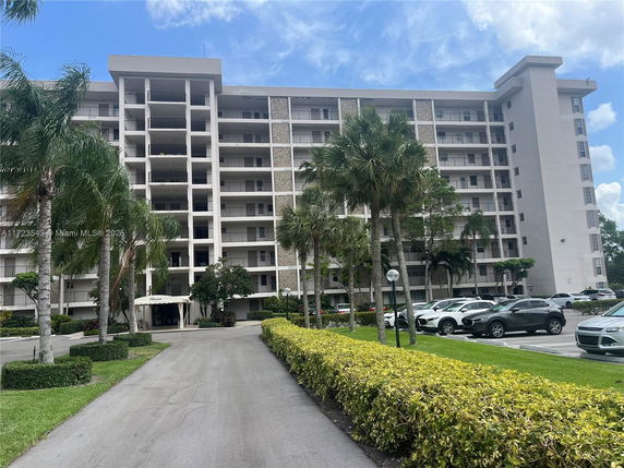 Front view of a multi-story residential building with balconies.