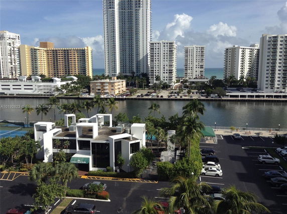 View of multiple high-rise buildings with a canal in the foreground.