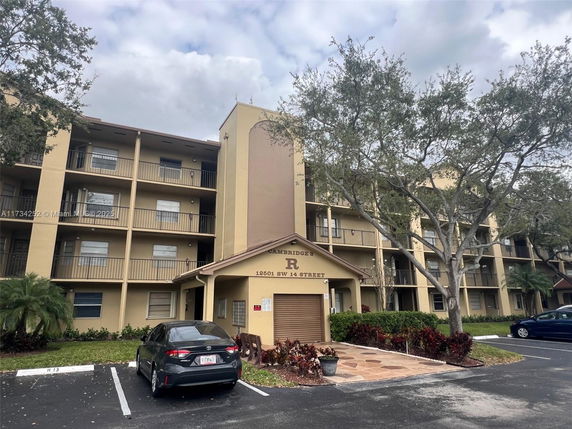 Front view of a multi-story residential building with balconies.