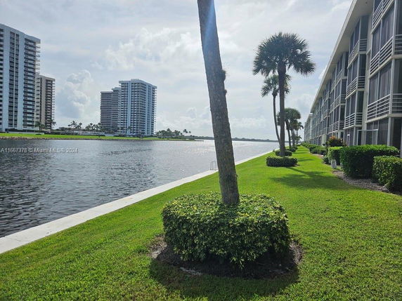 View of waterfront high-rise buildings and a nearby canal.