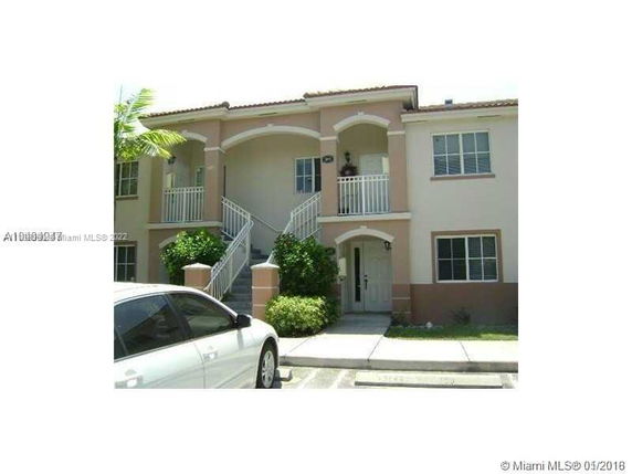 Front view of a two-story residential building with balconies.