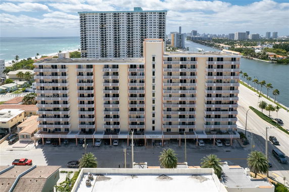 Front view of a multi-story residential building with balconies.