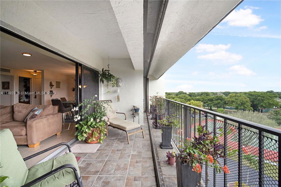Balcony view overlooking greenery and residential area.