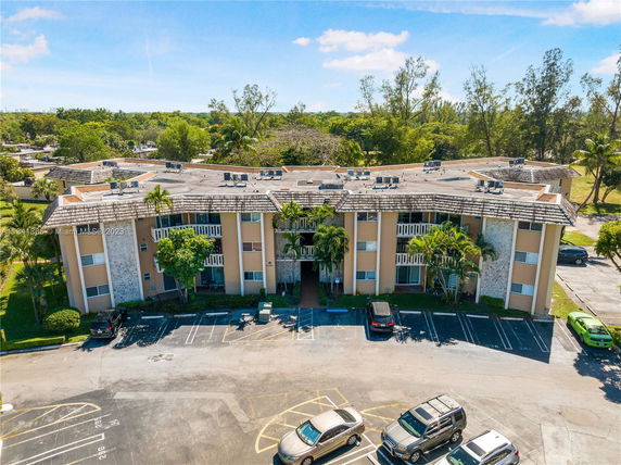 Front view of a multi-story apartment building with balconies.