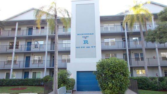 Front view of a multi-story residential building with balconies.