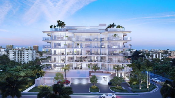 Front view of a modern multi-story apartment building with large balconies.