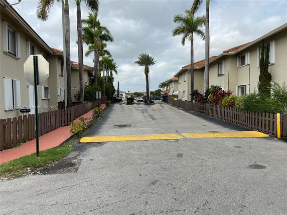 Front view of a residential building complex with two-story buildings and a driveway.
