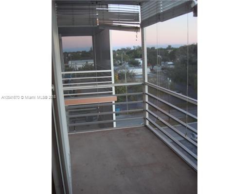 View from a balcony showing surrounding buildings and horizon.