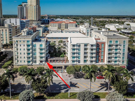 Front view of a mid-rise residential building with multiple balconies.