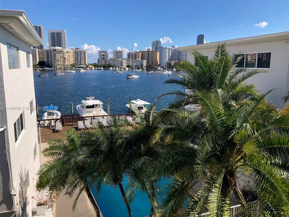 View of waterfront buildings and boats on a sunny day.