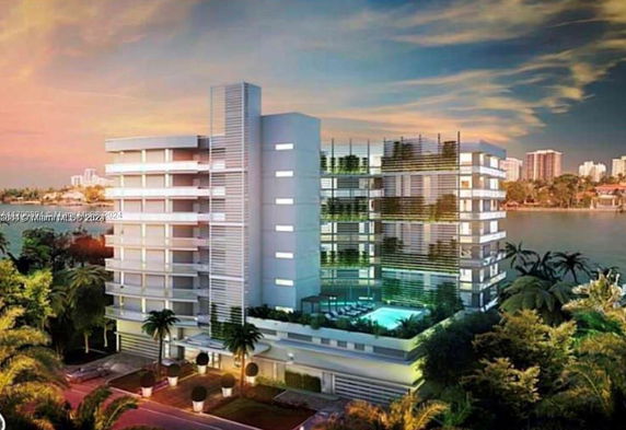 Front view of a multi-story building with a modern design and balconies.