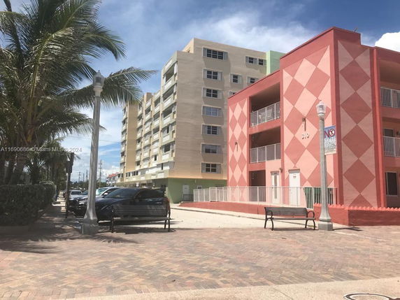 Front view of a multi-story apartment building with geometric patterns.