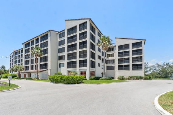 Front view of a multi-story residential building with balconies.