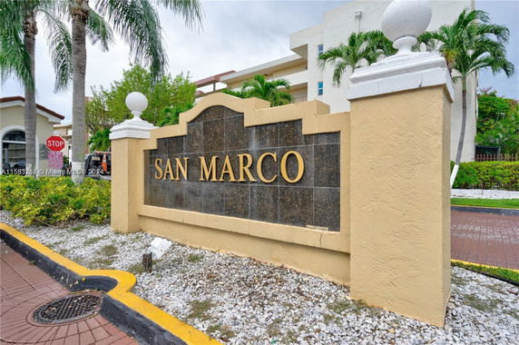 Entrance sign for San Marco community with surrounding landscaping.