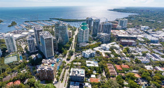 Aerial view of a coastal city with high-rise buildings and waterfront.