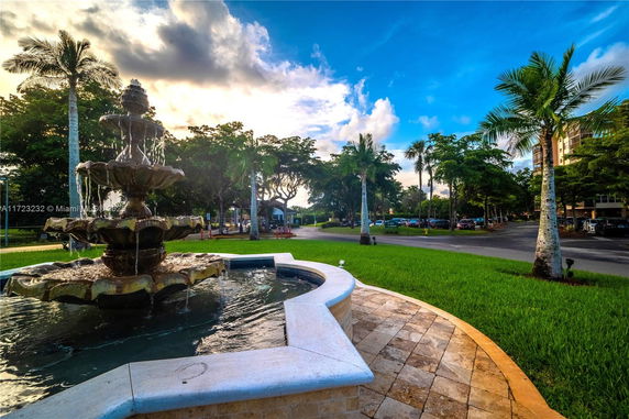 Outdoor view with a decorative water fountain and lush green surroundings.