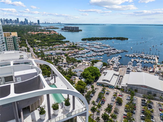 High-angle view of a marina with numerous boats and surrounding cityscape.