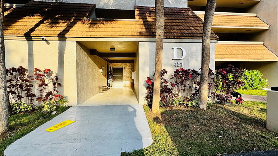Front view of a building entrance with a number and letter signage.