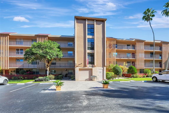 Front view of a multi-story residential building with balconies.