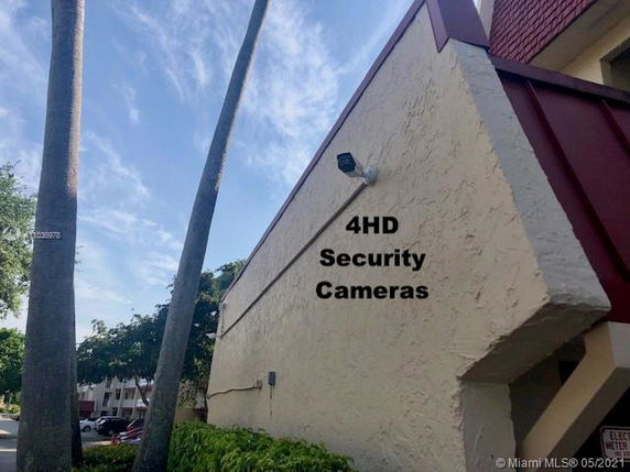 Side view of a building with security cameras installed.