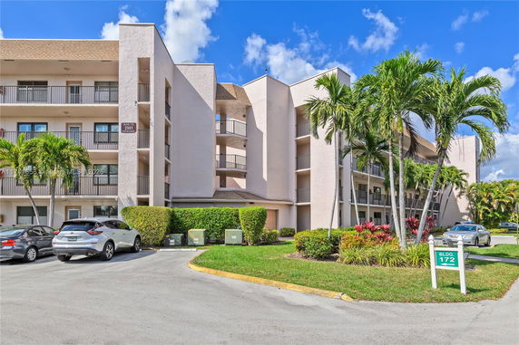 Front view of a multi-story residential building with balconies.