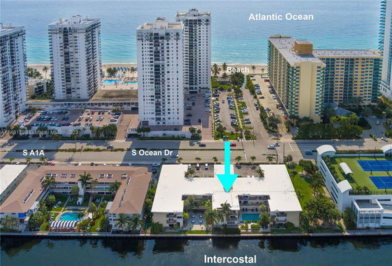 Aerial view of a coastal area with high-rise buildings near the Atlantic Ocean and surrounding infrastructure.