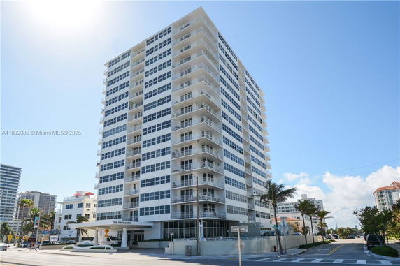 Front view of a multi-story residential building with balconies.