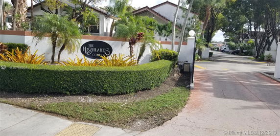 Entrance sign of The Highlands condos with landscaping.