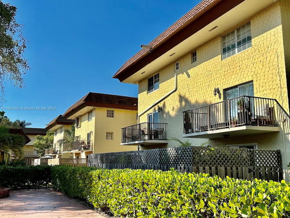 Front view of a multi-story building with balconies.