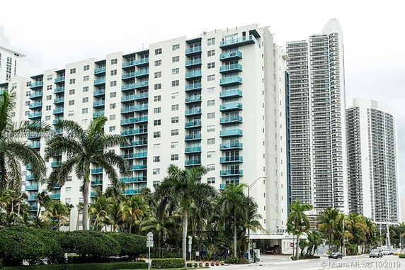 Front view of a multi-story residential building with balconies.