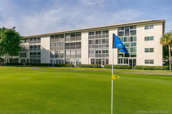 Front view of a multi-story building with large windows.
